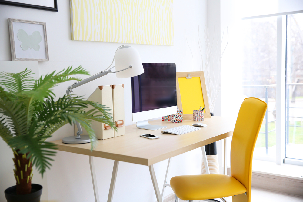 office desk with yellow chair in natural light