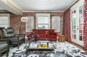a-loft-3 coffee table couch two chairs red brick wall
