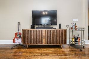 a-loft-5 wood tv stand with flatscreen in a loft ellecor