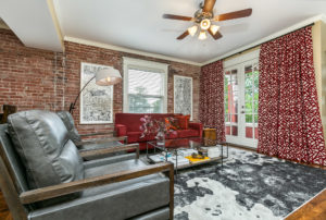 Living room view with bricks, windows, and curtains Ellecor Interior Design Lofts 6