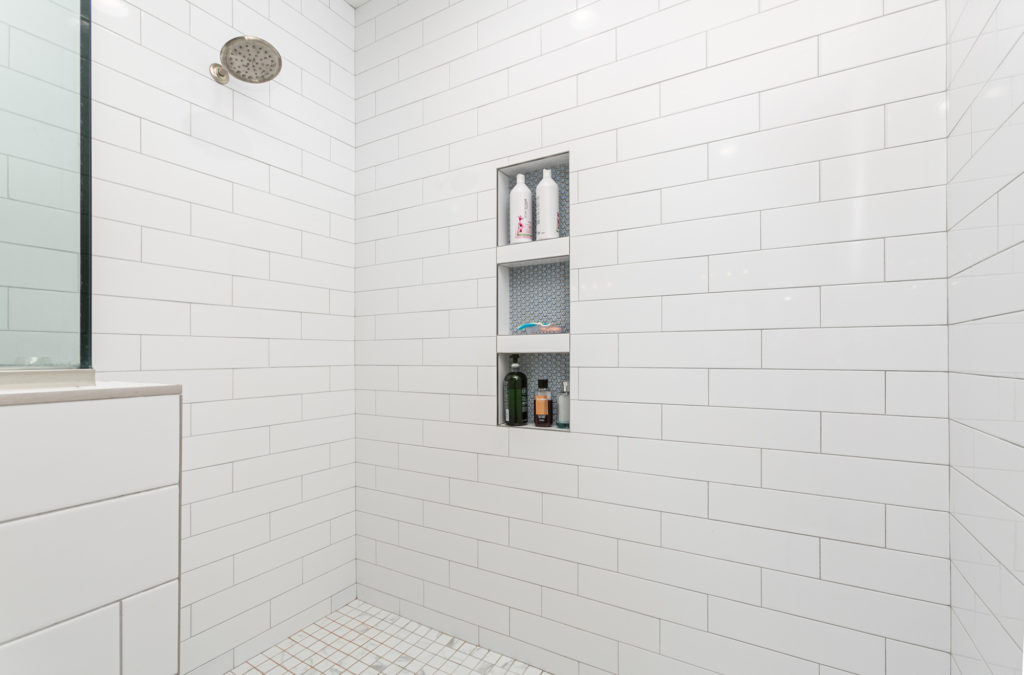 Large shower with embedded shelves and tiled walls abby-farm-house-19