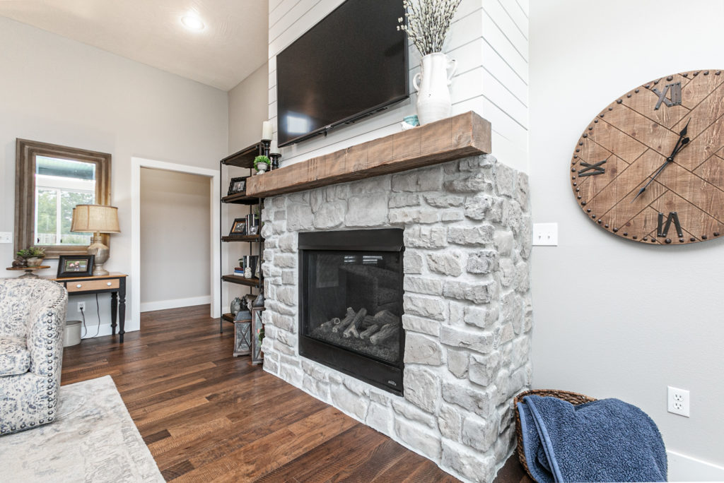 Hearth and gas fireplace with flatscreen TV above it abby-farm-house-9