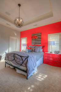Child's bedroom with red walls and striped bedding apple-way-home-10