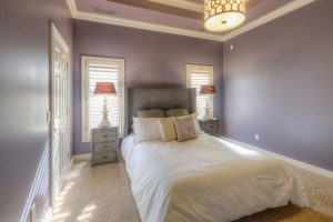 Guest bedroom with lace bedding and purple walls apple-way-home-11