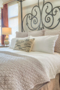 Close-up of master bed with iron headboard apple-way-home-7