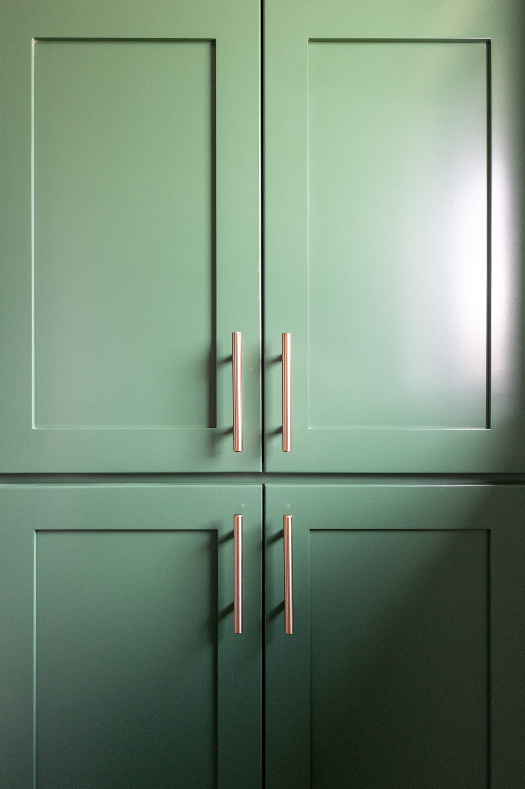 green cabinets with gold handles