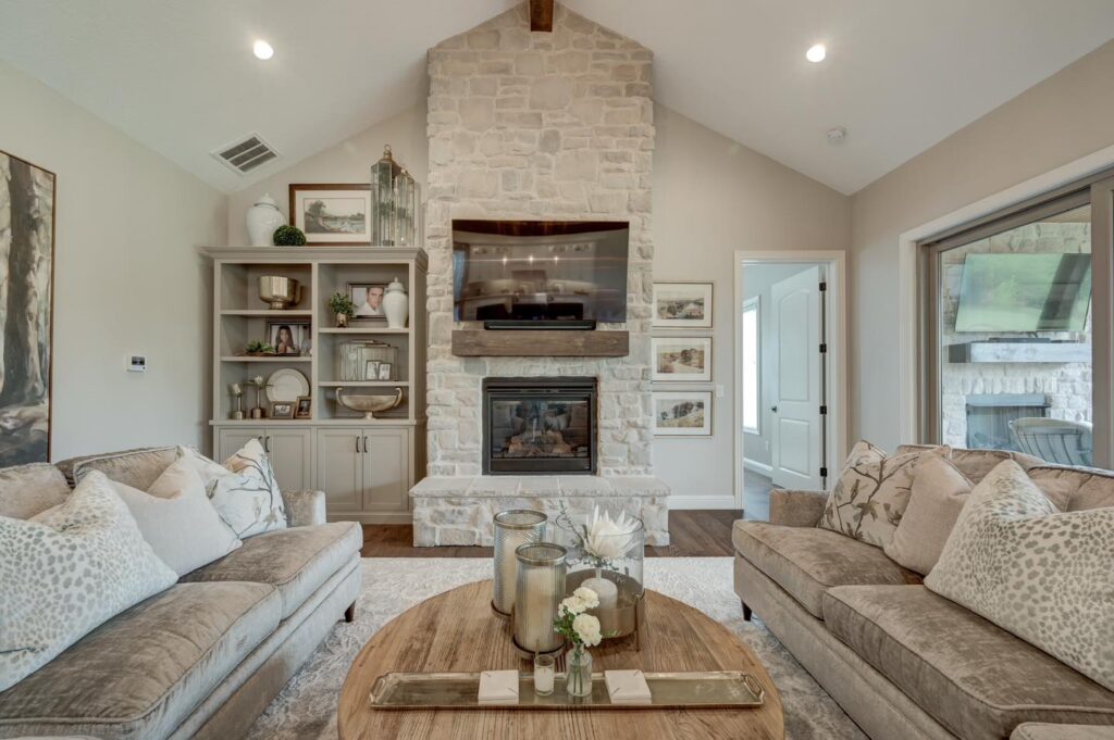 Cozy home entertainment space with stone fireplace and neutral colors